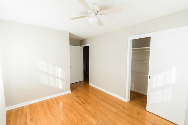 unfurnished bedroom with light hardwood / wood-style flooring, a closet, and ceiling fan