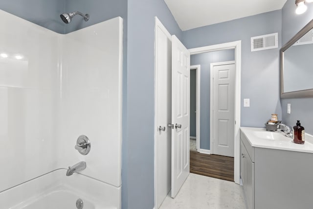 bathroom with wood-type flooring, vanity, and shower / bath combination