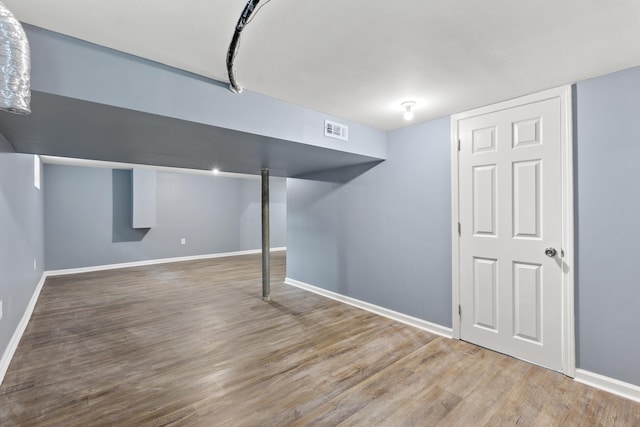 basement featuring hardwood / wood-style flooring