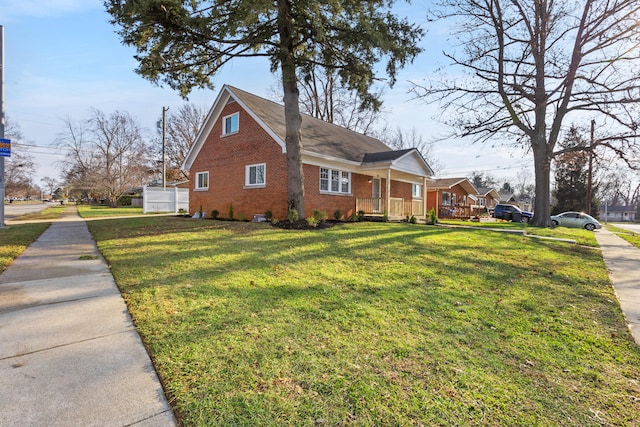 view of home's exterior with a lawn and covered porch