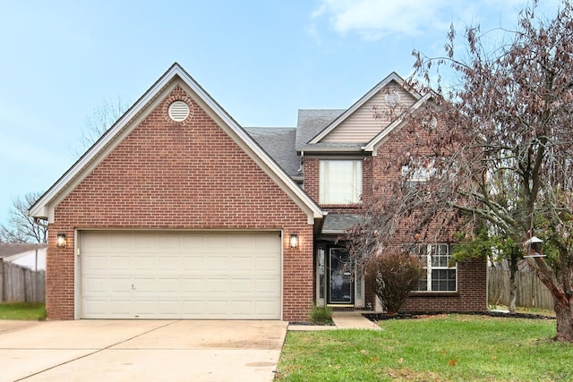 view of front of home with a front yard and a garage