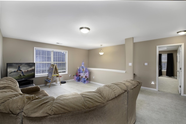 living room featuring light colored carpet and plenty of natural light