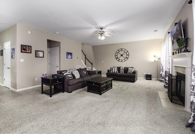 carpeted living room with ceiling fan