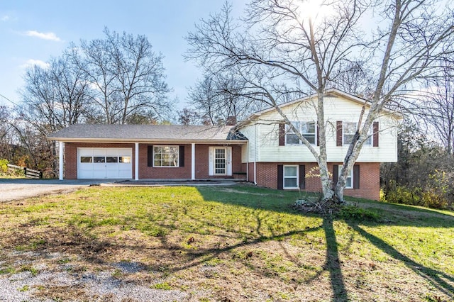 split level home featuring a garage, a front lawn, and covered porch