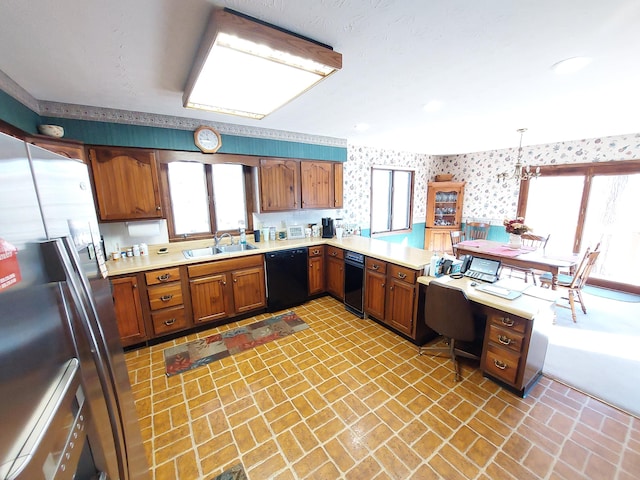 kitchen featuring kitchen peninsula, sink, pendant lighting, stainless steel fridge with ice dispenser, and black dishwasher