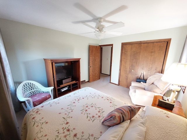 carpeted bedroom with ceiling fan and a closet