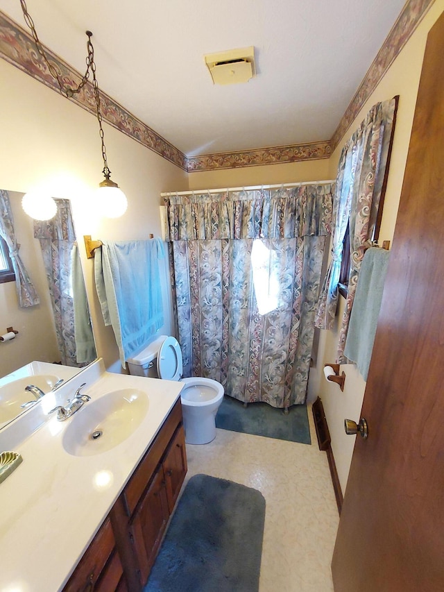 bathroom featuring vanity and toilet