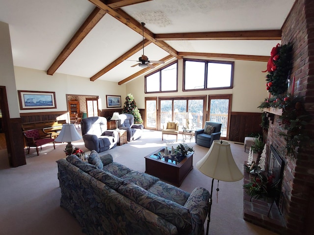 living room featuring wooden walls, a fireplace, carpet, and ceiling fan