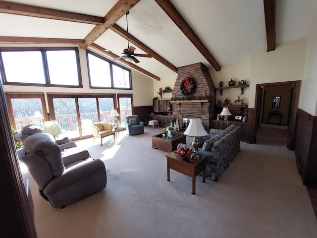 living room with beam ceiling, ceiling fan, high vaulted ceiling, light carpet, and a fireplace