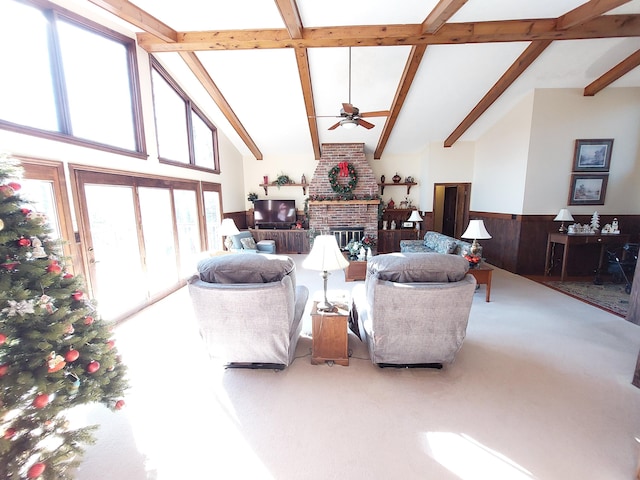 living room featuring ceiling fan, beam ceiling, high vaulted ceiling, and a brick fireplace