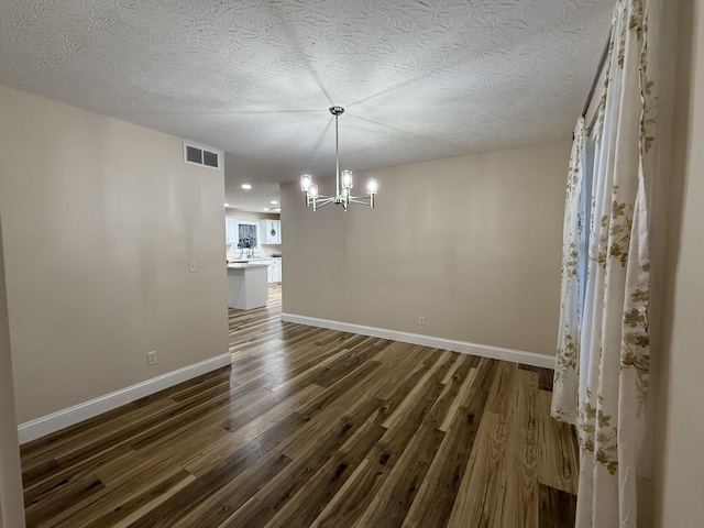 18 Ash Dr, Nancy, KY 42544 - unfurnished dining area featuring a chandelier, dark wood-style flooring, baseboards, a textured ceiling, and recessed lighting