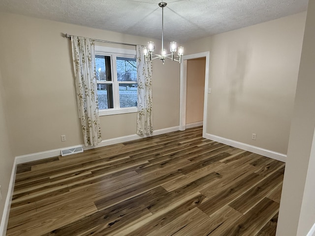18 Ash Dr, Nancy, KY 42544 - unfurnished dining area featuring a textured ceiling, a chandelier, dark wood finished floors, and baseboards