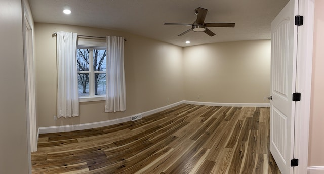 unfurnished room with hardwood / wood-style flooring, a healthy amount of sunlight, a textured ceiling, and ceiling fan