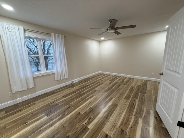 spare room featuring ceiling fan and wood-type flooring