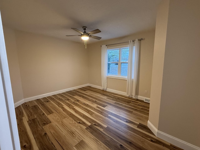 18 Ash Dr, Nancy, KY 42544 - unfurnished room featuring dark wood-style floors, a ceiling fan, and baseboards