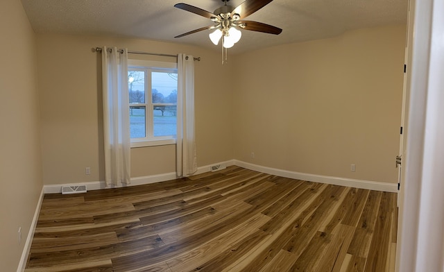 spare room with hardwood / wood-style flooring, a textured ceiling, and ceiling fan