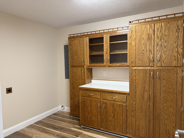 kitchen with dark wood-type flooring, electric panel, and a textured ceiling