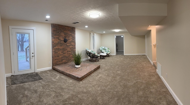 interior space featuring carpet floors and a textured ceiling