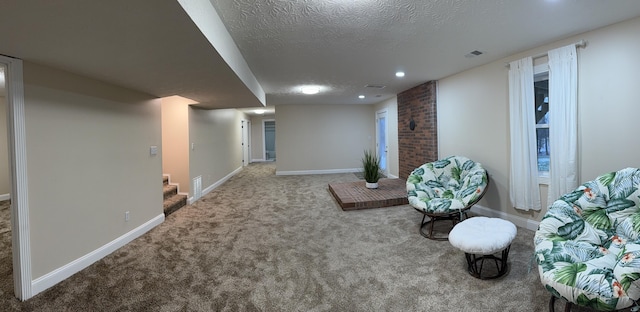 living area featuring carpet floors and a textured ceiling