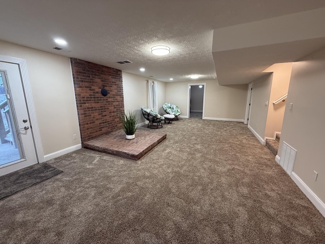 basement with carpet floors and a textured ceiling