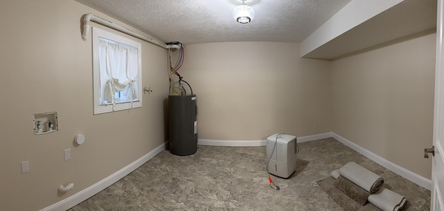 laundry area featuring hookup for a washing machine, water heater, and a textured ceiling