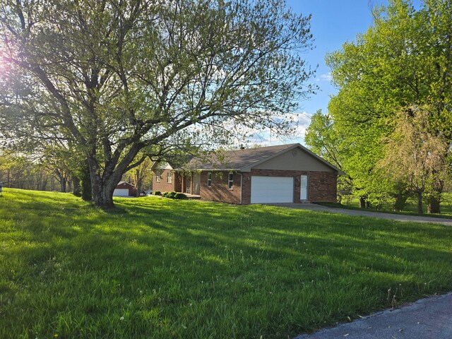 18 Ash Dr, Nancy, KY 42544 - view of front of house with brick siding, a garage, a front lawn, and asphalt driveway