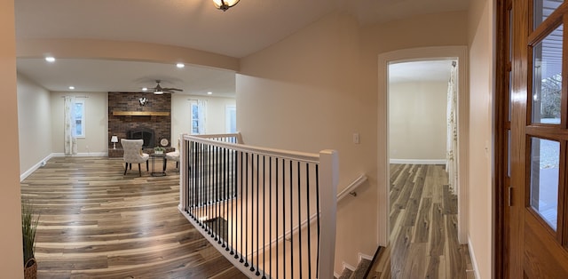 18 Ash Dr, Nancy, KY 42544 - hallway featuring wood finished floors, an upstairs landing, baseboards, recessed lighting, and arched walkways