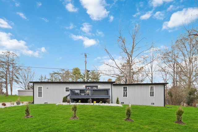 back of property with a lawn and a wooden deck