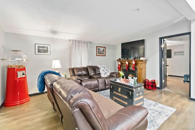 living room with lofted ceiling and light wood-type flooring