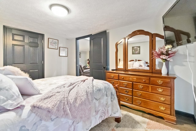 carpeted bedroom with a textured ceiling