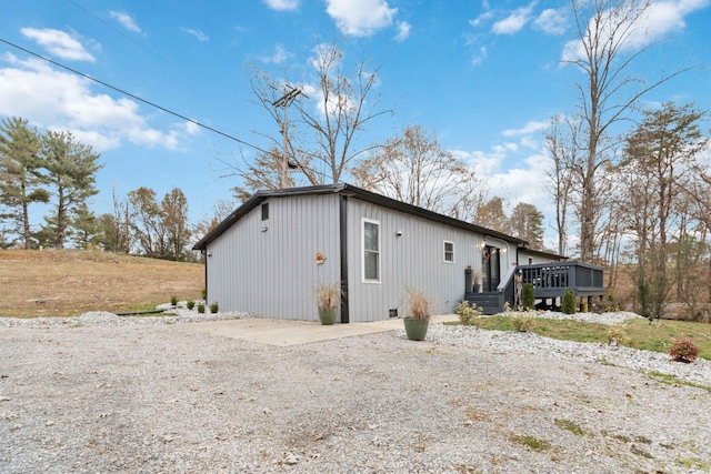 view of property exterior with a wooden deck