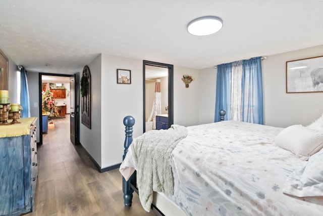 bedroom with dark hardwood / wood-style floors and connected bathroom