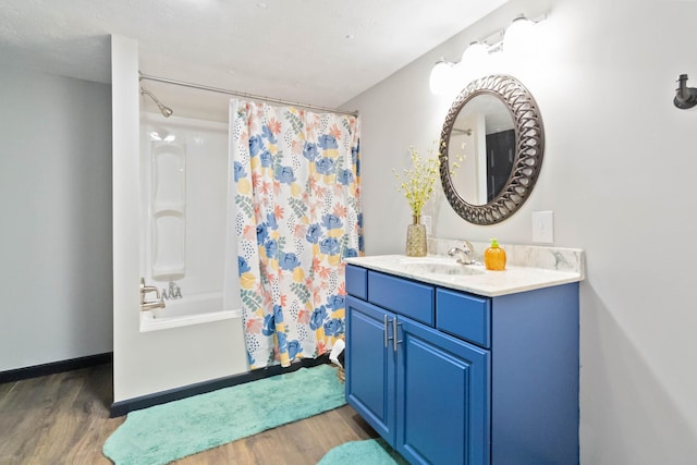 bathroom featuring vanity, hardwood / wood-style flooring, and shower / bathtub combination with curtain