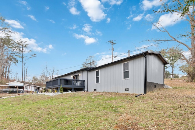 back of property featuring a yard and a deck