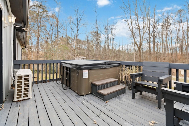 wooden deck featuring a hot tub