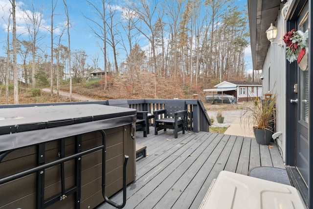 wooden terrace featuring a hot tub