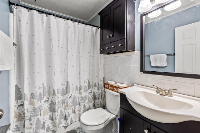 bathroom featuring vanity, backsplash, crown molding, toilet, and a textured ceiling