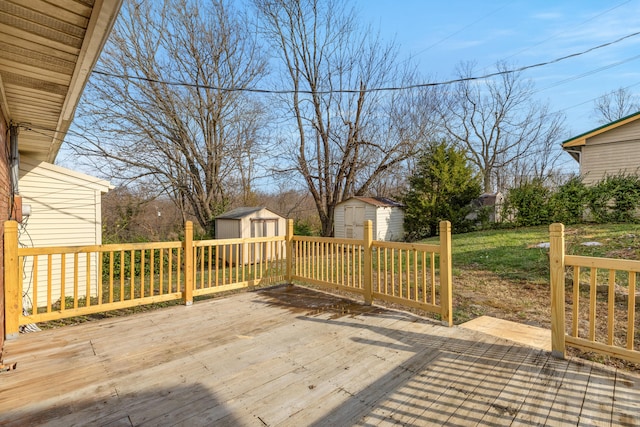 deck featuring a yard and a storage unit