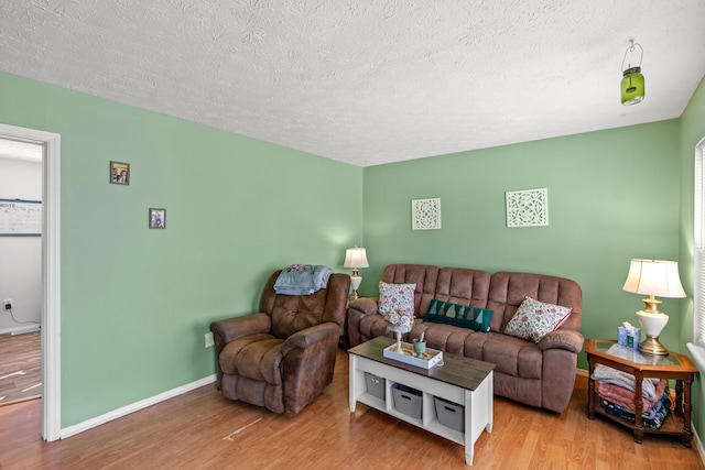 living room featuring hardwood / wood-style floors and a textured ceiling