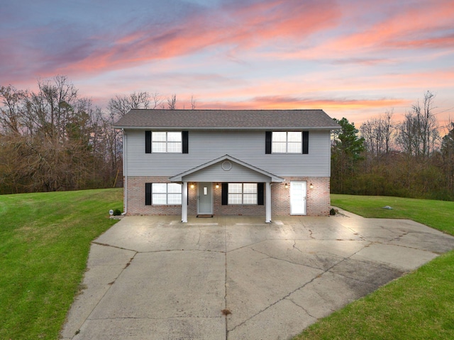 view of front of home featuring a carport and a lawn