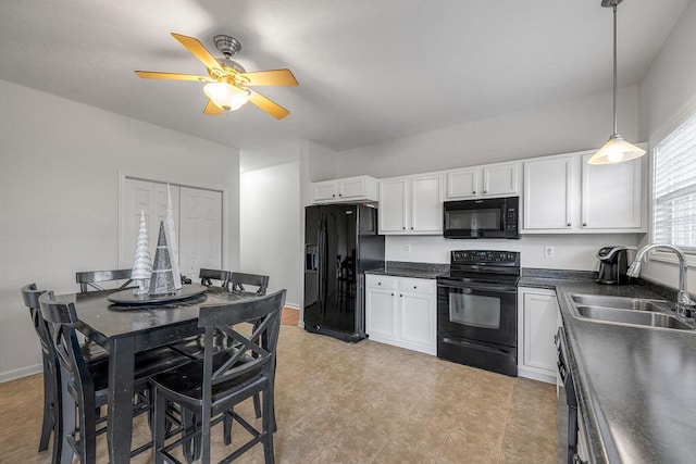 kitchen featuring pendant lighting, sink, white cabinets, and black appliances