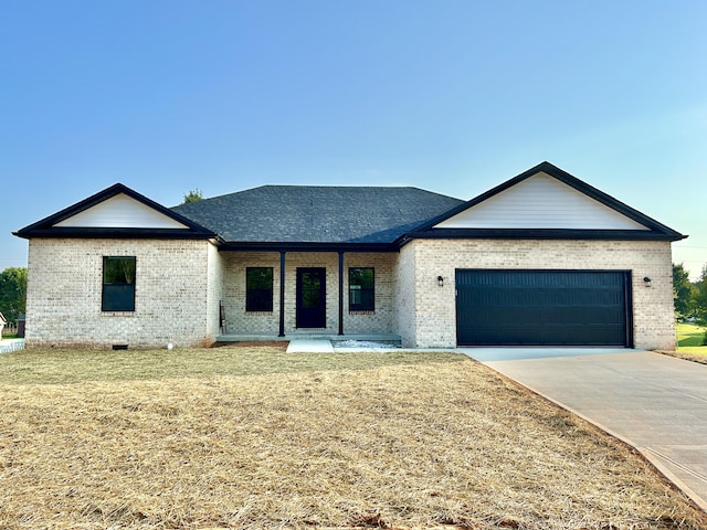 view of front facade with a porch, a garage, and a front yard