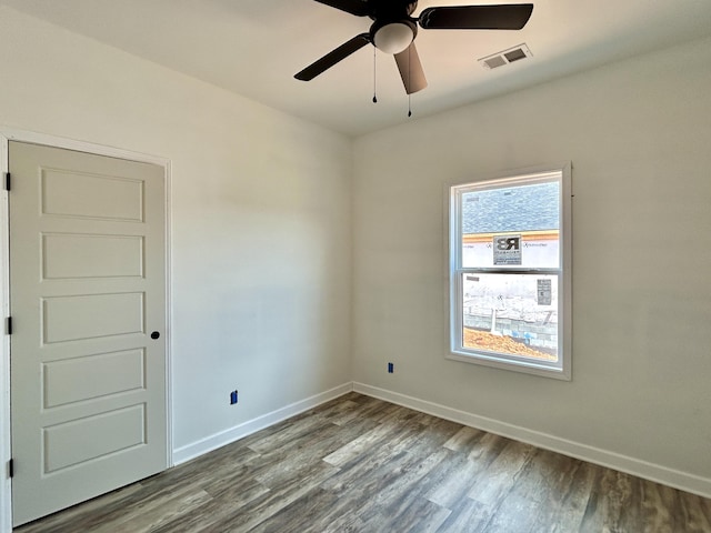 spare room featuring wood-type flooring and ceiling fan