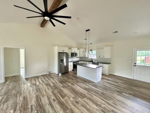 kitchen featuring a center island, white cabinets, hanging light fixtures, hardwood / wood-style flooring, and stainless steel appliances