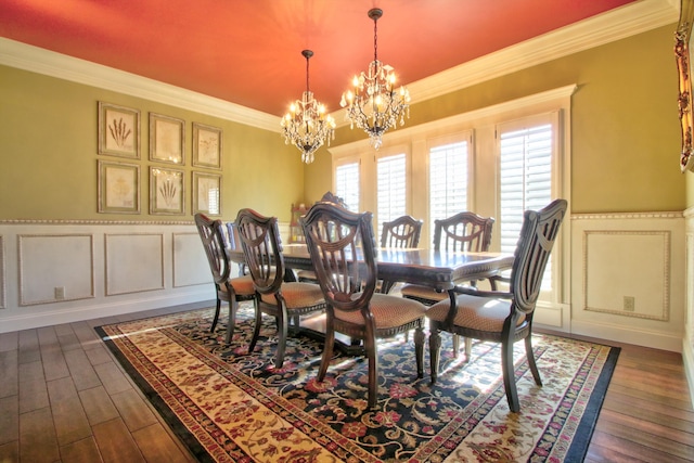 dining area with crown molding, dark wood-style flooring, a notable chandelier, and a decorative wall