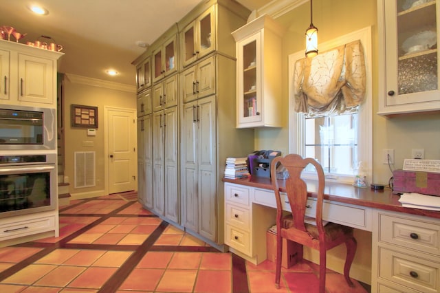 kitchen with light tile patterned flooring, recessed lighting, visible vents, built in desk, and crown molding