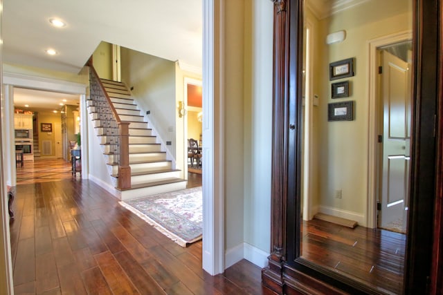 interior space featuring dark wood-style floors, recessed lighting, stairway, ornamental molding, and baseboards