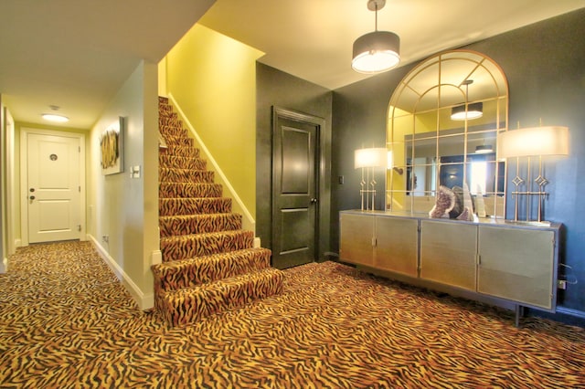 staircase with carpet and baseboards