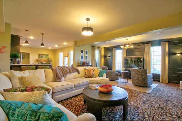 living area featuring a chandelier and carpet floors