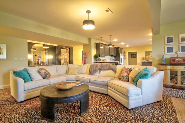 living room with carpet floors, baseboards, and visible vents